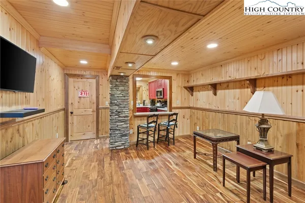 a view of a room with furniture and wooden floor