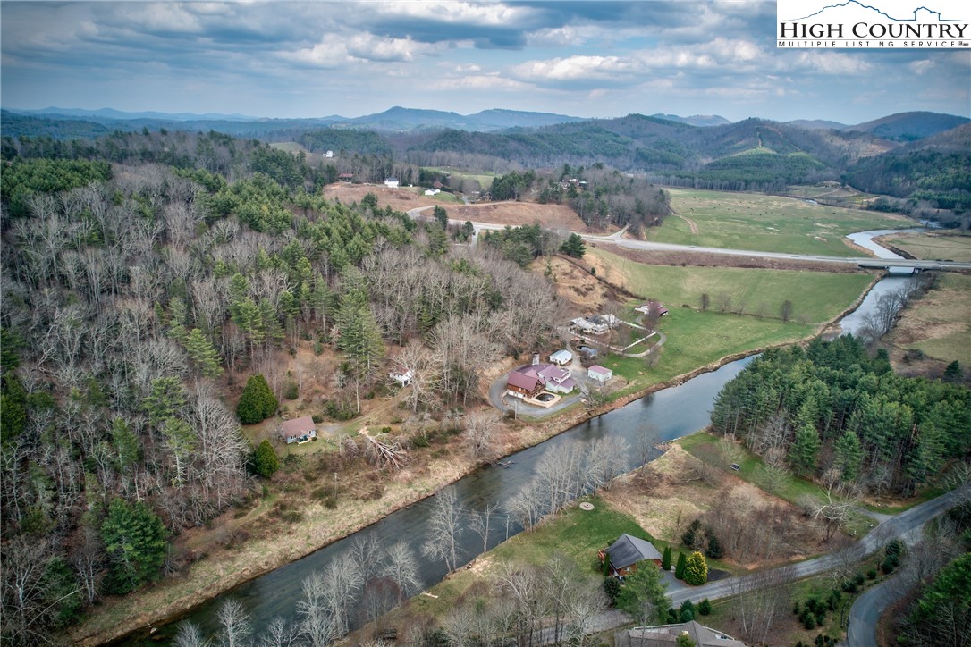 262 Lemly Road Fleetwood, NC 28626 - Photo 2 of 37 a view of a lake with a mountain and trees in the background