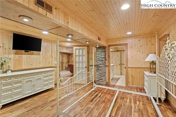 a view of a livingroom with wooden floor and furniture