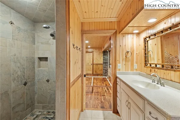 a bathroom with a shower sink and mirror