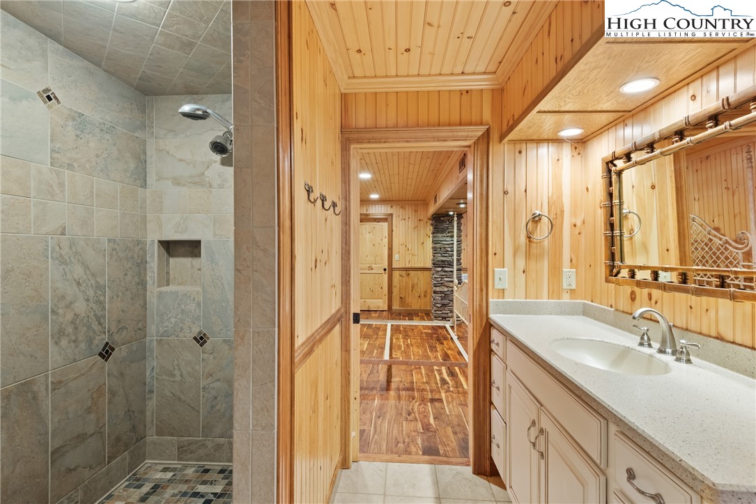 262 Lemly Road Fleetwood, NC 28626 - Photo 23 of 37 a bathroom with a shower sink and mirror