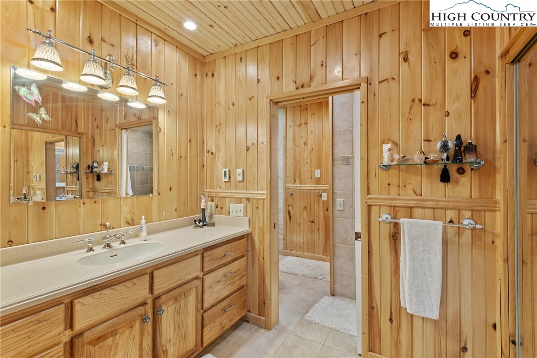 262 Lemly Road Fleetwood, NC 28626 - Photo 26 of 37 a bathroom with a double vanity sink mirror and shower