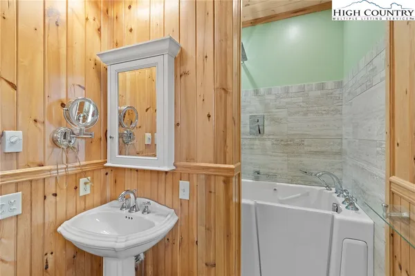 a bathroom with a sink a mirror and a shower