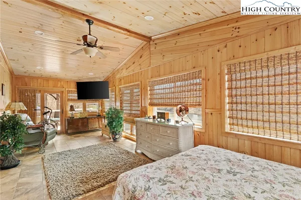 a bedroom with furniture and a flat screen tv