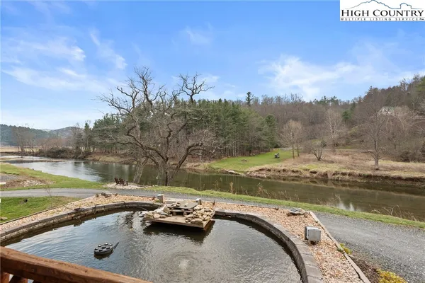 a view of a swimming pool with a yard and a fountain