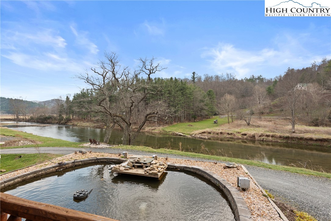 262 Lemly Road Fleetwood, NC 28626 - Photo 30 of 37 a view of a swimming pool with a yard and a fountain