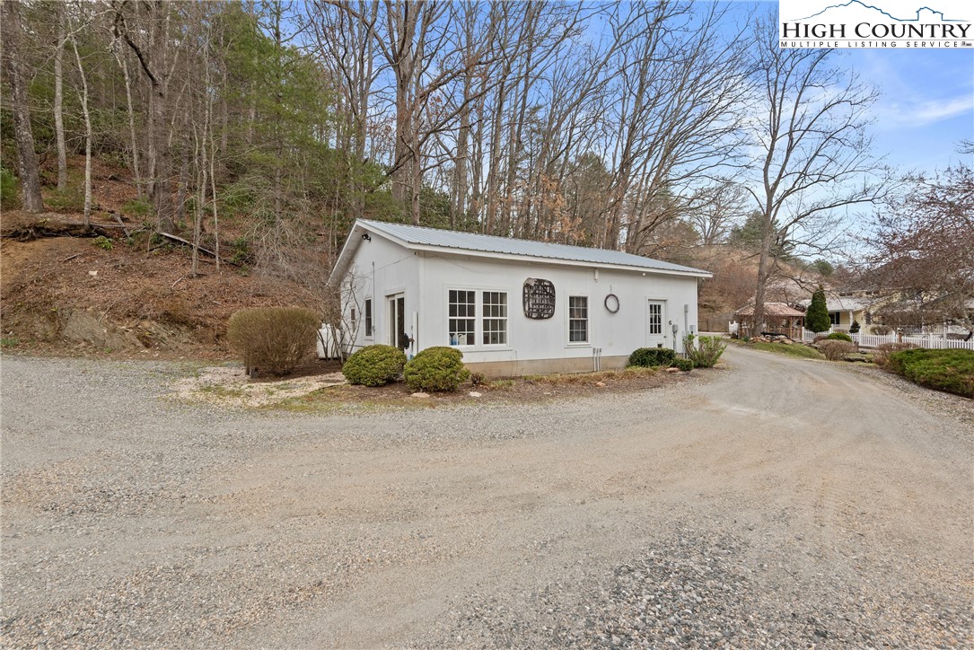 262 Lemly Road Fleetwood, NC 28626 - Photo 32 of 37 a view of a house with a yard covered in snow