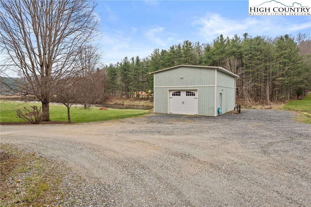 262 Lemly Road Fleetwood, NC 28626 - Photo 33 of 37 a view of a house with a yard and large tree