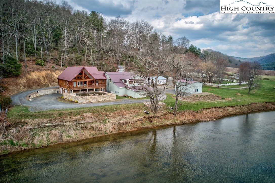 262 Lemly Road Fleetwood, NC 28626 - Photo 36 of 37 a view of a lake with houses lake and trees