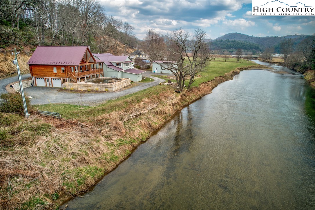 262 Lemly Road Fleetwood, NC 28626 - Photo 37 of 37 a view of a lake with a yard