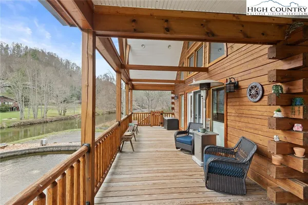 a view of a balcony with chairs and wooden floor