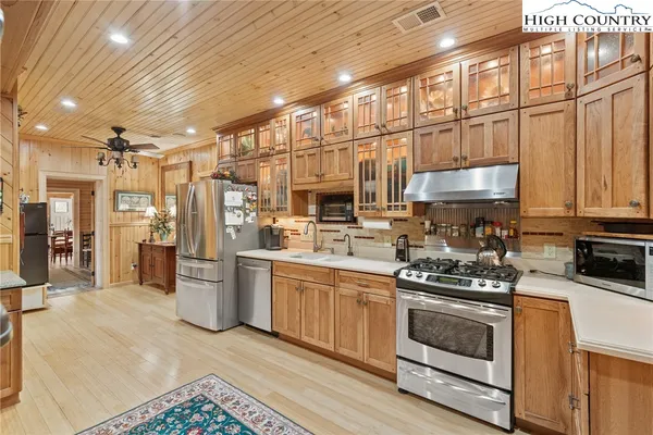 a kitchen with stainless steel appliances granite countertop a stove and a refrigerator