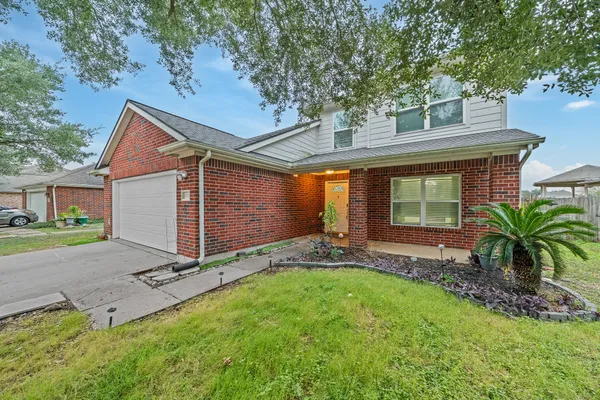 a front view of house with yard and outdoor seating
