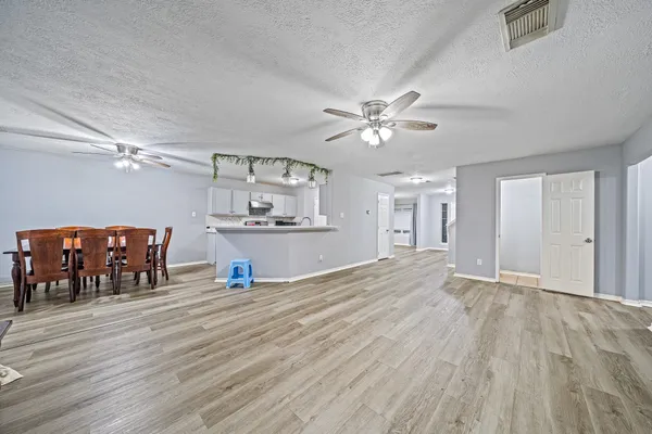 a view of a livingroom with furniture and a kitchen