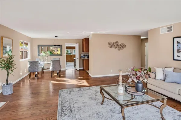 a living room with furniture and wooden floor