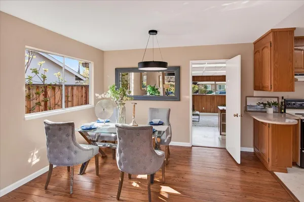 a view of a dining room with furniture window and wooden floor