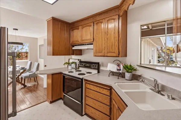 a kitchen with stainless steel appliances granite countertop a sink stove and cabinets