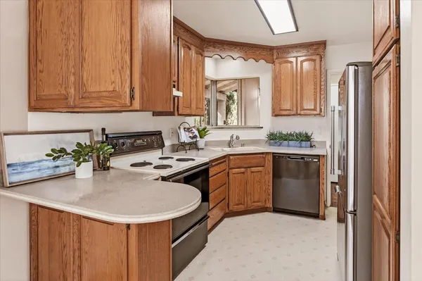 a kitchen with a sink appliances and cabinets