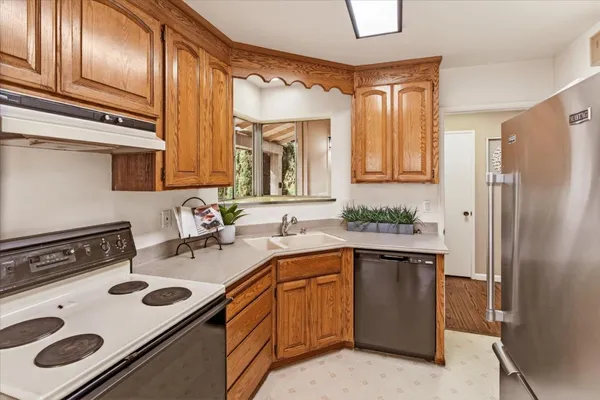 a kitchen with a sink stove and refrigerator