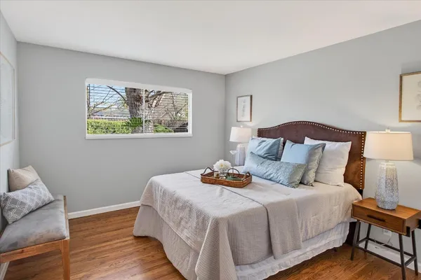 a bedroom with a bed and wooden floor