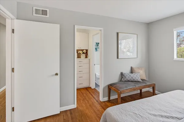 a bedroom with furniture and a window