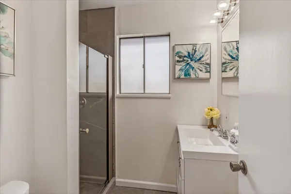 a bathroom with a sink and mirror with toilet