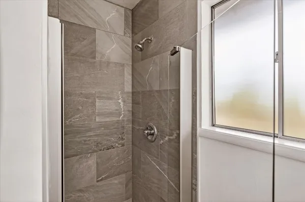 a bathroom with a glass shower door