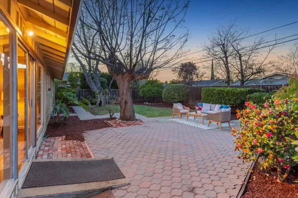 a view of a patio with table and chairs and potted plants