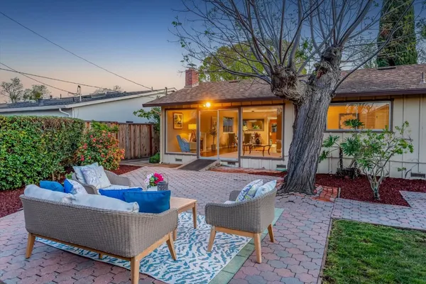 a house view with a sitting space and garden