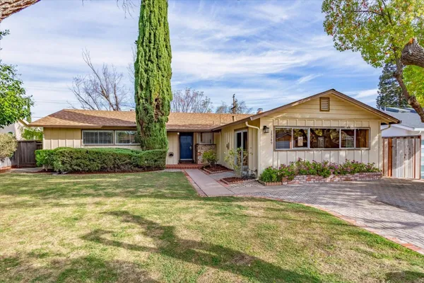 a front view of a house with garden