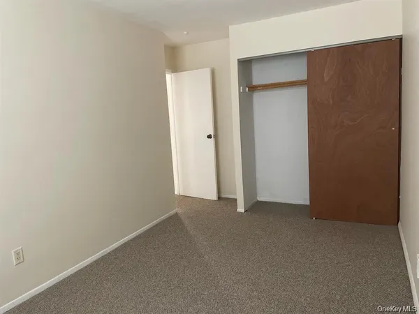 an empty room with closet area