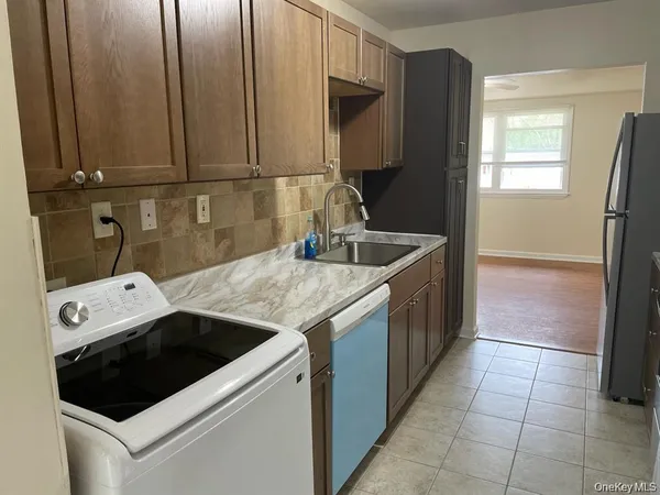 a kitchen with a sink and a refrigerator