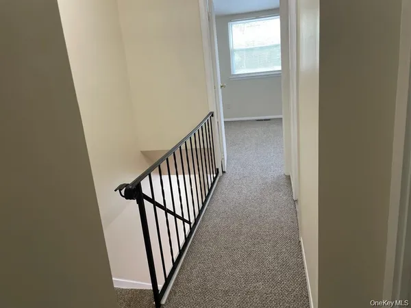 a view of a hallway with a window