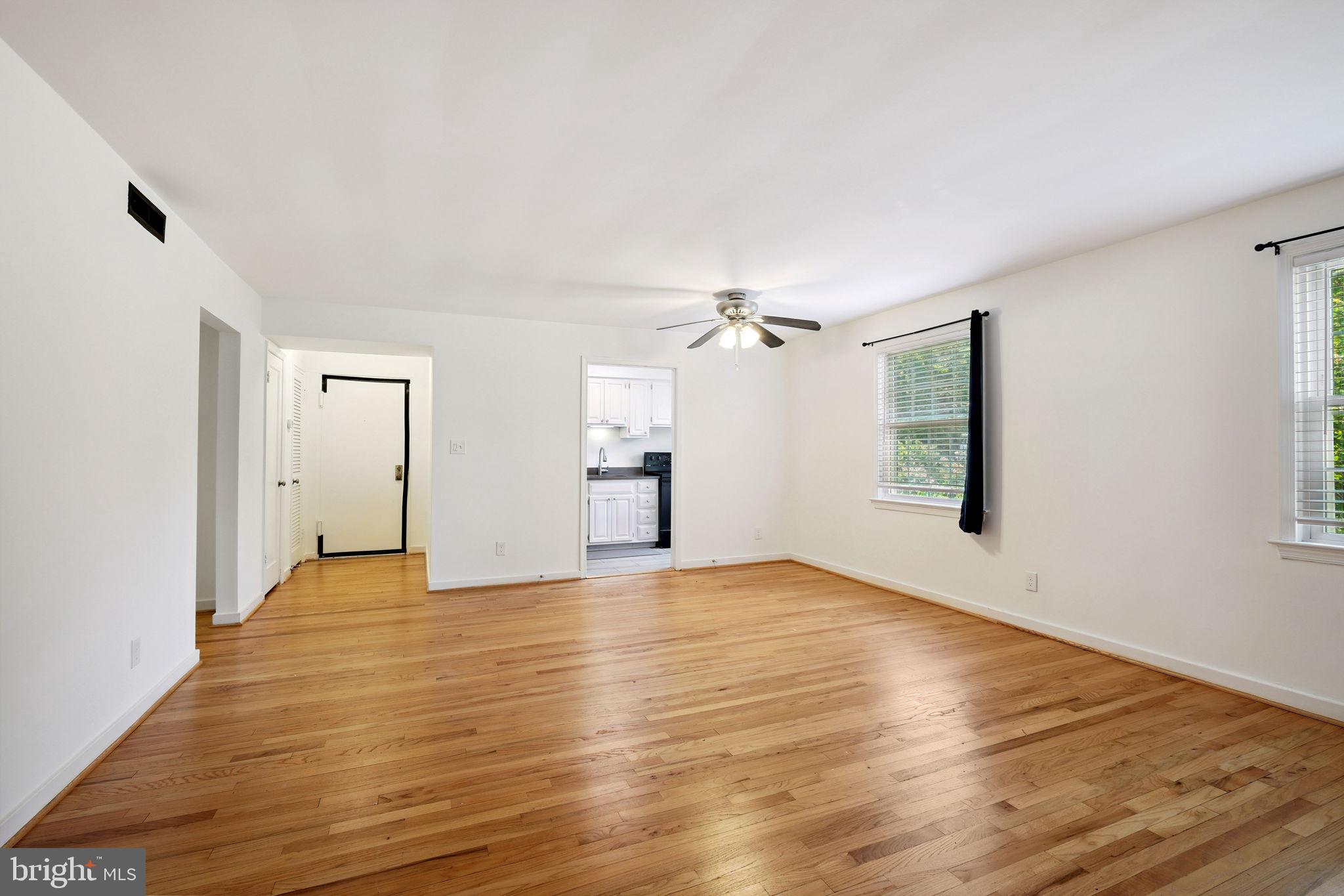 8203 Grubb Road, Unit 201 Silver Spring, MD 20910 - Photo 11 of 26 wooden floor in an empty room with a window