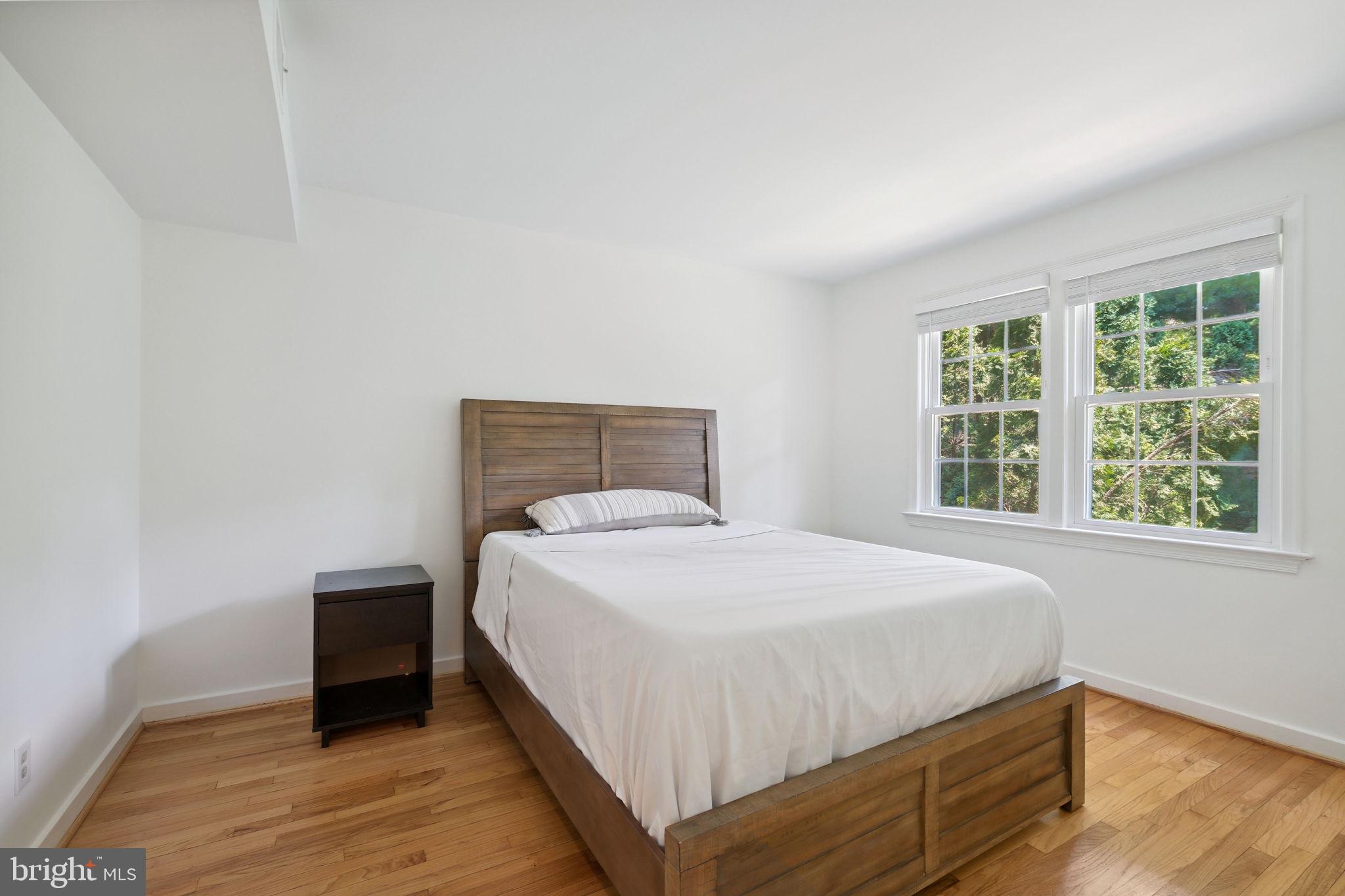 8203 Grubb Road, Unit 201 Silver Spring, MD 20910 - Photo 12 of 26 a bedroom with a bed and wooden floor