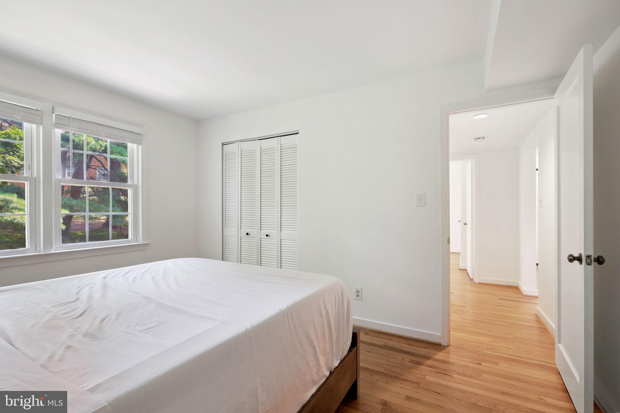 8203 Grubb Road, Unit 201 Silver Spring, MD 20910 - Photo 13 of 26 a spacious bedroom with a bed and wooden floor