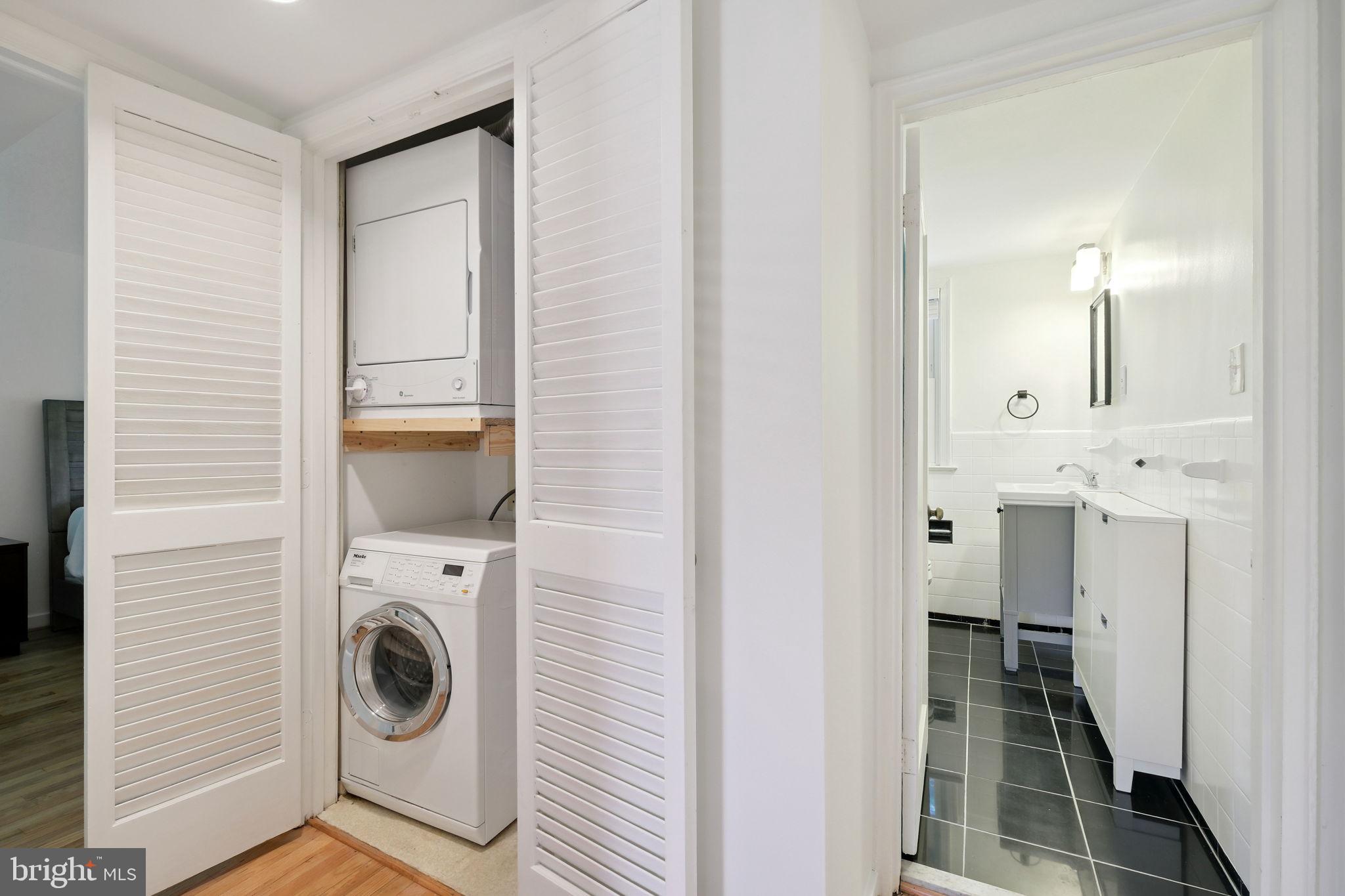 8203 Grubb Road, Unit 201 Silver Spring, MD 20910 - Photo 14 of 26 a view of a hallway with washer and dryer