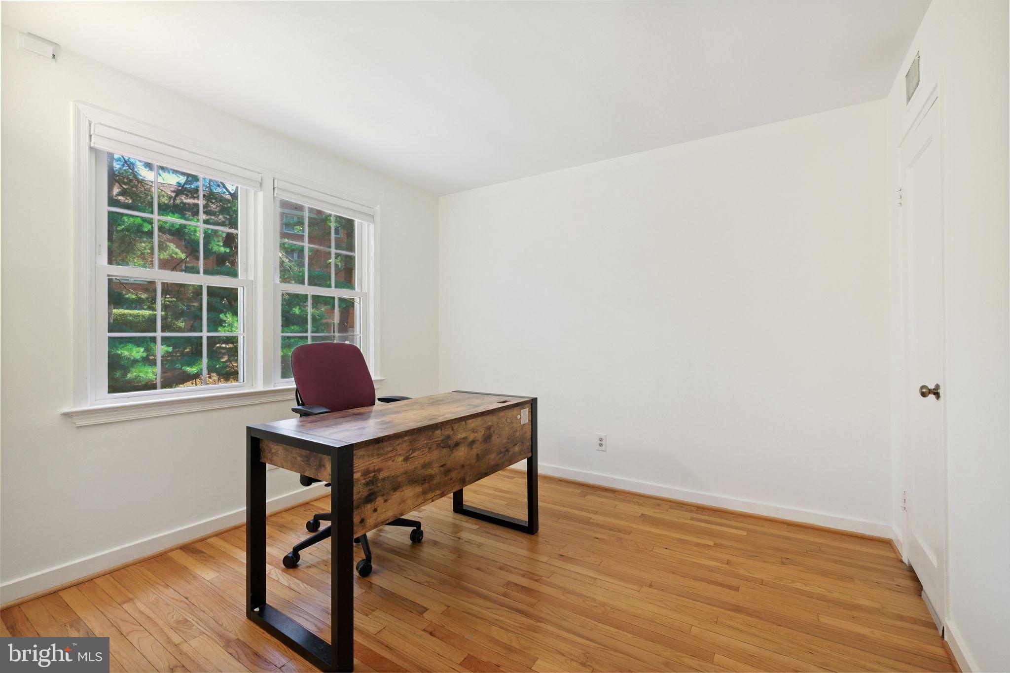 8203 Grubb Road, Unit 201 Silver Spring, MD 20910 - Photo 16 of 26 a view of a workspace with wooden floor and a window