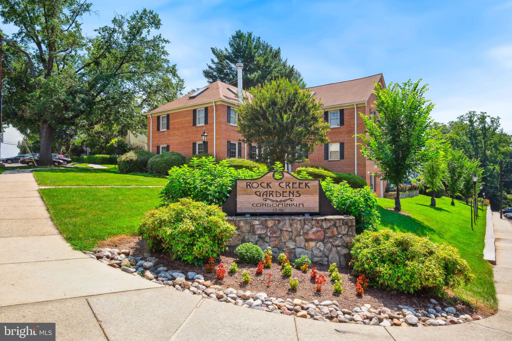 8203 Grubb Road, Unit 201 Silver Spring, MD 20910 - Photo 18 of 26 a front view of a house with a yard
