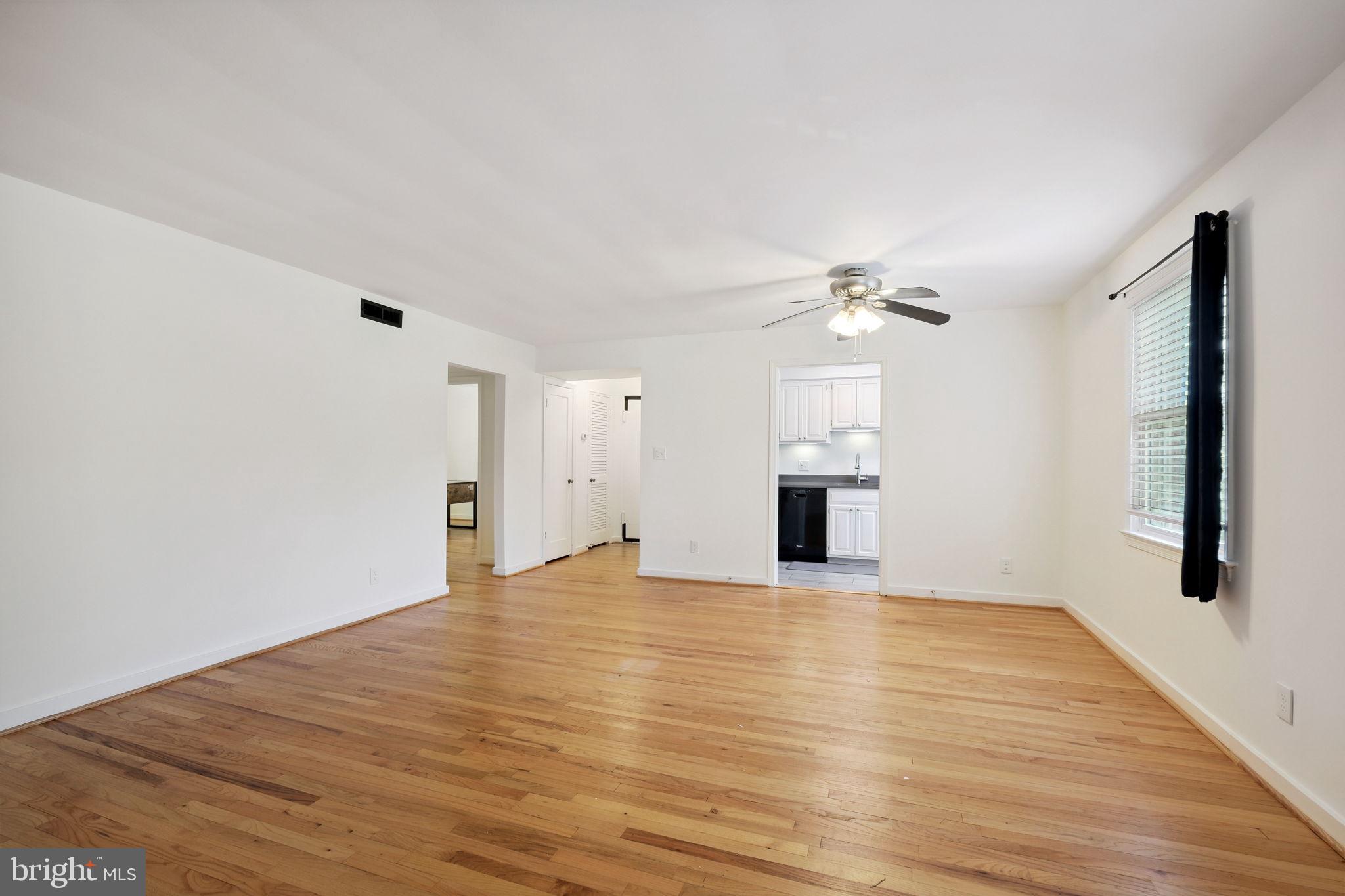 8203 Grubb Road, Unit 201 Silver Spring, MD 20910 - Photo 5 of 26 a view of empty room with wooden floor and fireplace