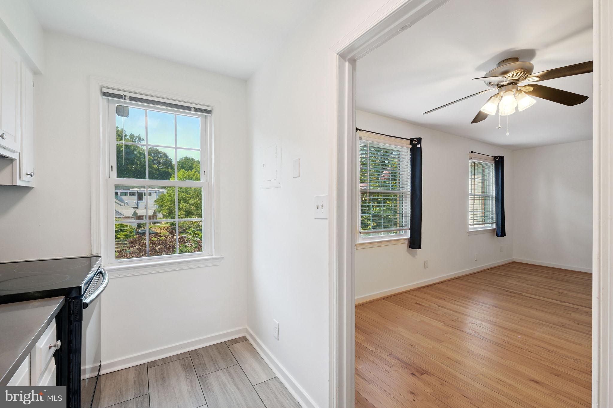 8203 Grubb Road, Unit 201 Silver Spring, MD 20910 - Photo 9 of 26 a view of an empty room with wooden floor and a window