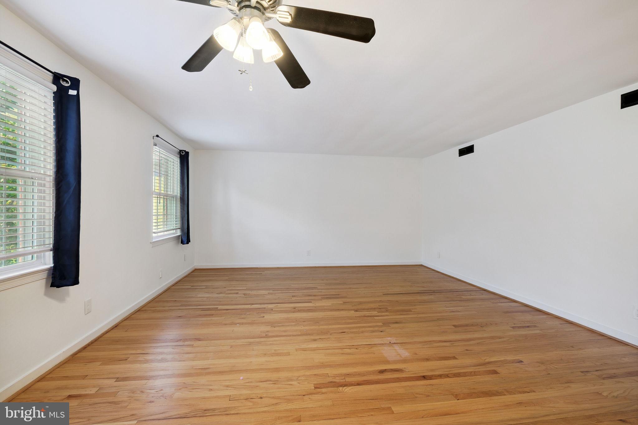 8203 Grubb Road, Unit 201 Silver Spring, MD 20910 - Photo 10 of 26 a view of an empty room with window and wooden floor