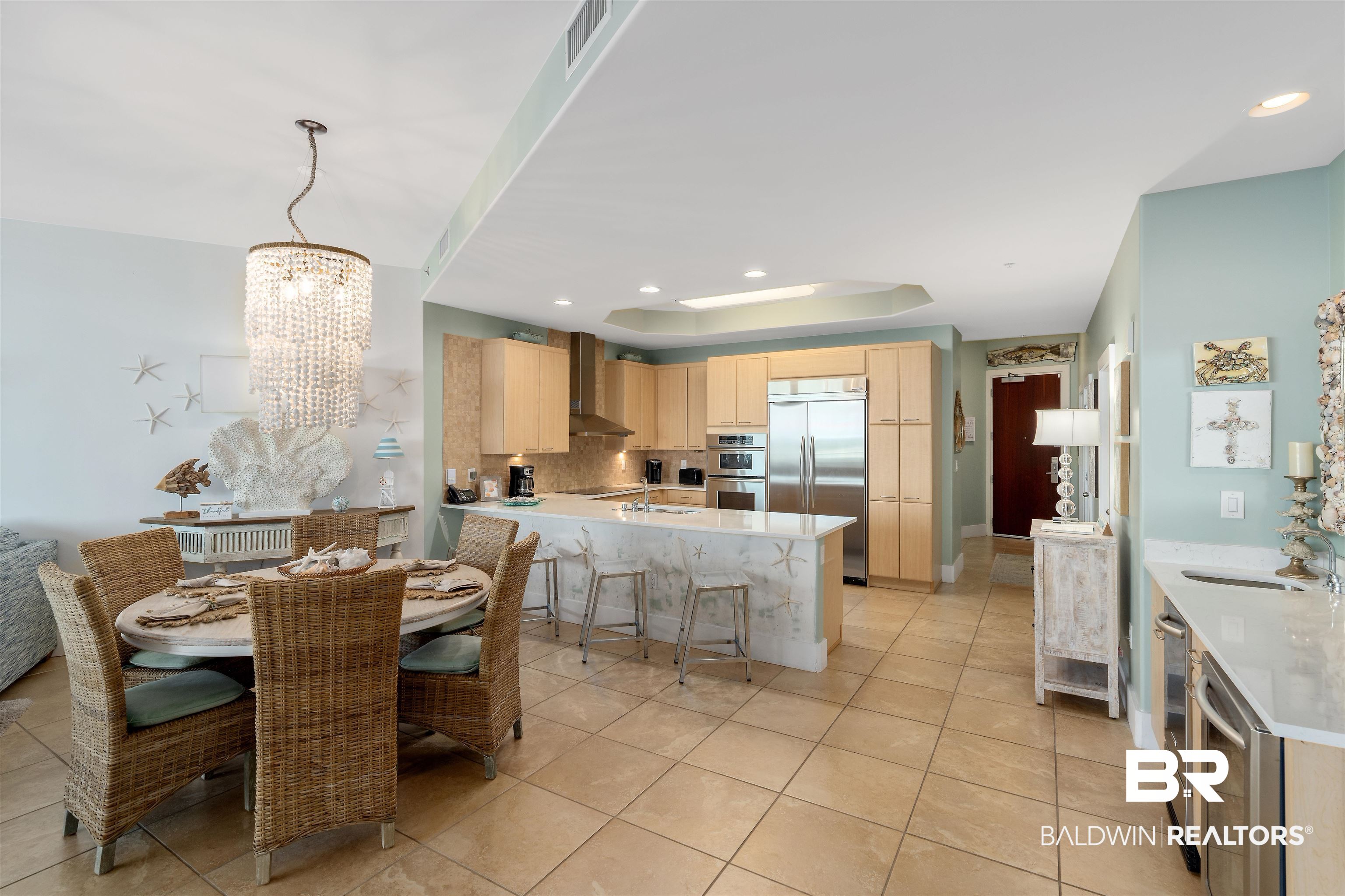28107 Perdido Beach Boulevard, Unit DPH06 Orange Beach, AL 36561 - Photo 8 of 70 Dining room with sink, a raised ceiling, a chandelier, and light tile patterned floors
