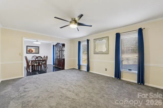 a view of a livingroom with furniture and ceiling fan