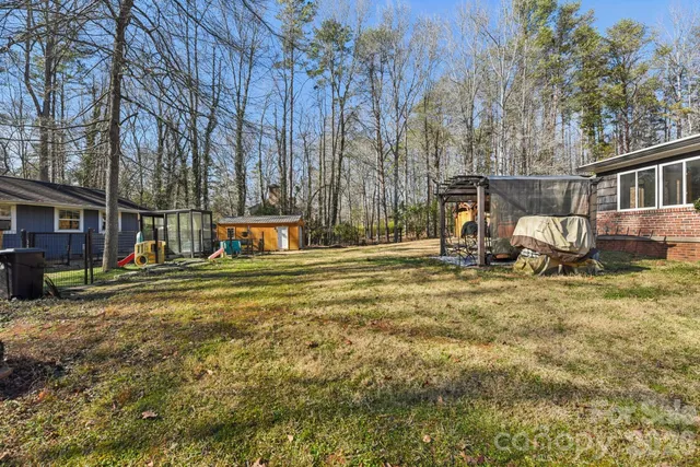 a backyard of a house with barbeque oven