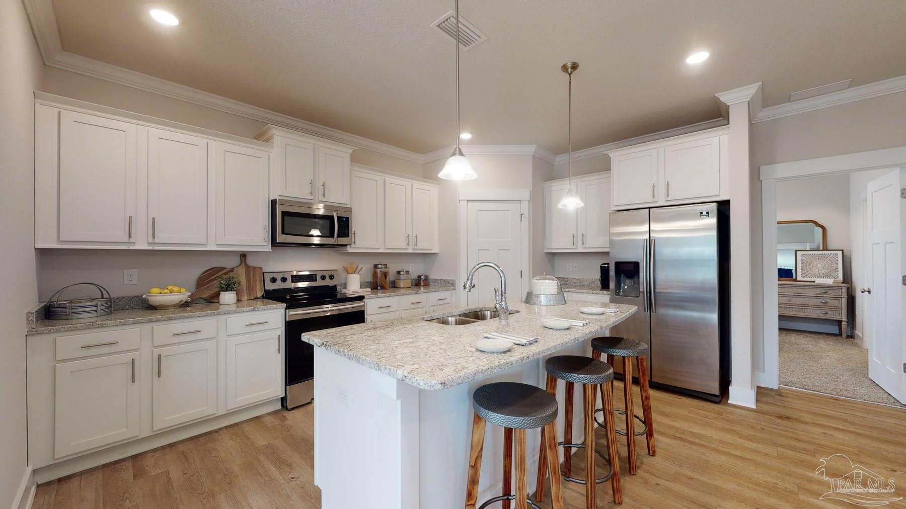 4531 Jude Way Pace, FL 32571 - Photo 14 of 43 a kitchen with a sink stainless steel appliances and white cabinets