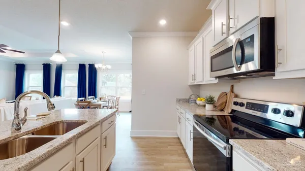 a kitchen that has a sink and a stove top oven