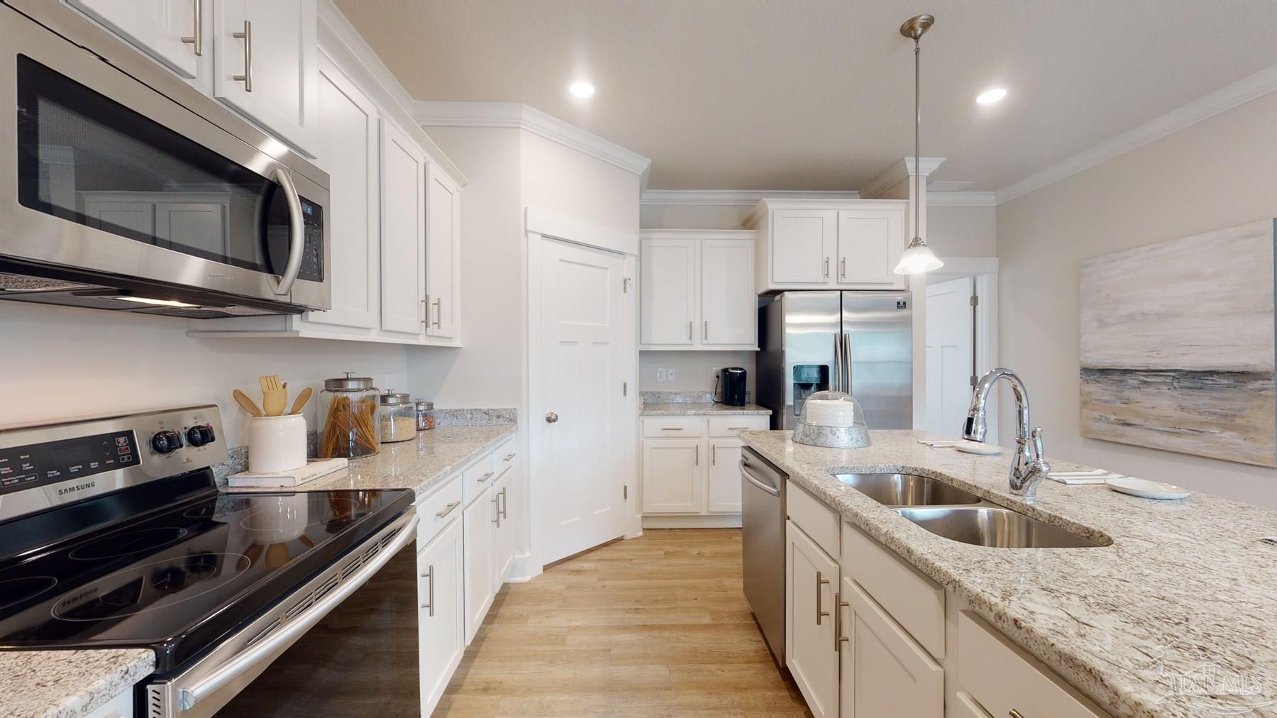 4531 Jude Way Pace, FL 32571 - Photo 17 of 43 a kitchen with stainless steel appliances granite countertop a sink a stove oven and a refrigerator with wooden floor