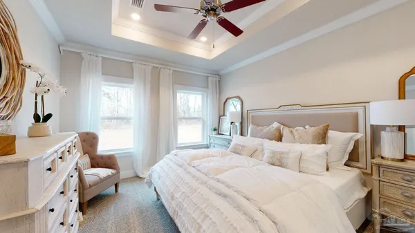 a bedroom with a bed and a chandelier