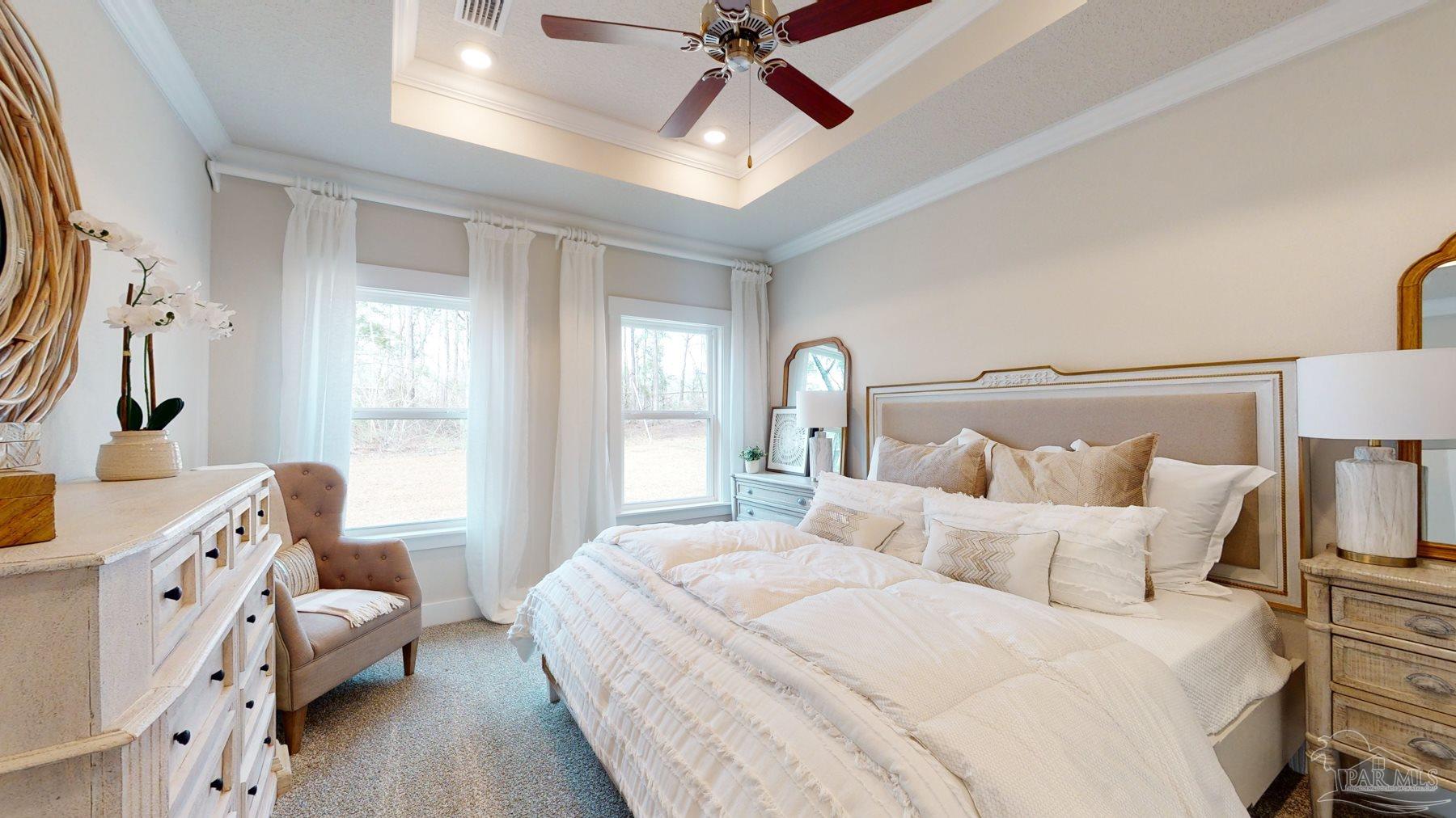 4531 Jude Way Pace, FL 32571 - Photo 19 of 43 a bedroom with a bed and a chandelier